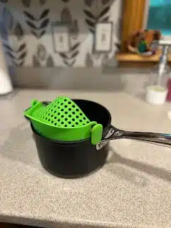 A clip-on strainer on one of my Le Creuset pans from the set. 