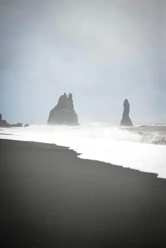 The black sand beach is a popular stop on the South Coast map.